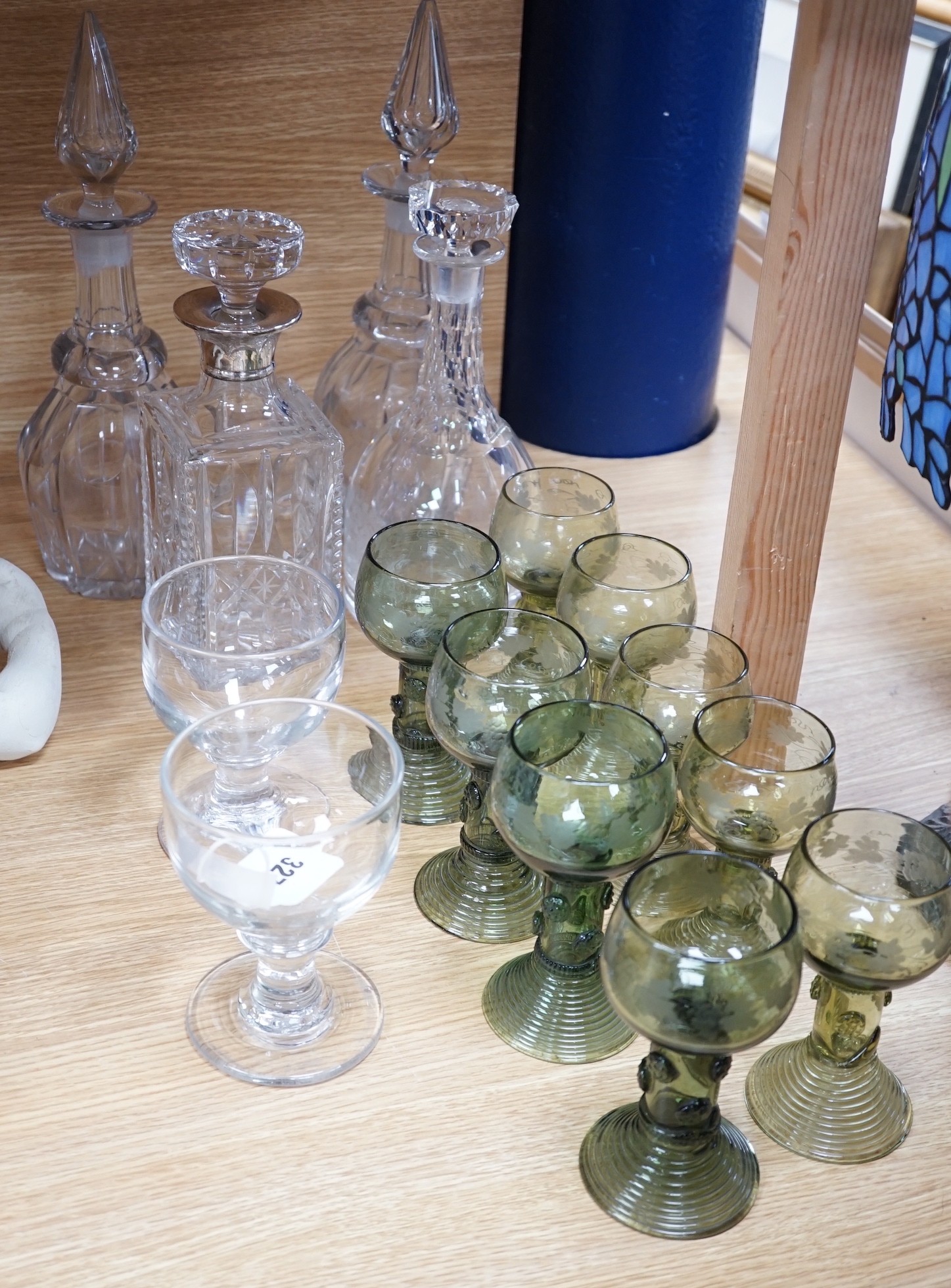 A pair of rummers, three glass decanters, a silver mounted decanter and nine etched green glass goblets, tallest 34cm